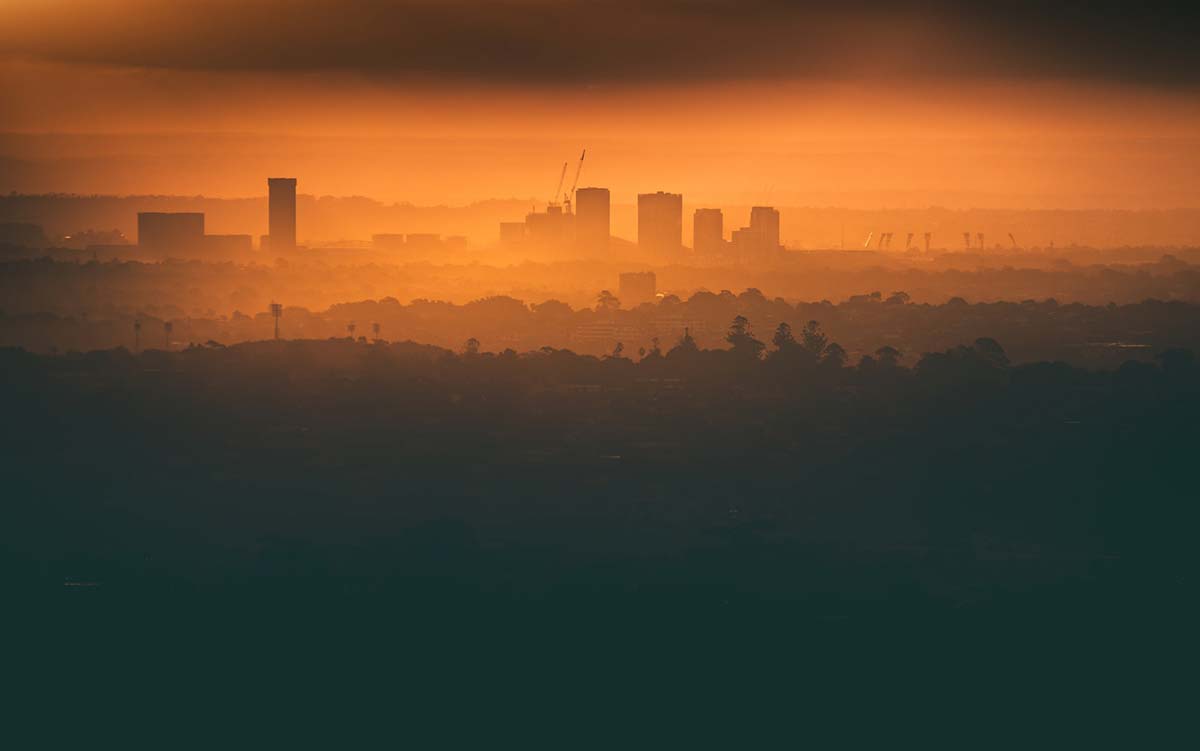 Zdjęcie miasta nocą z pomarańczową mgłą
