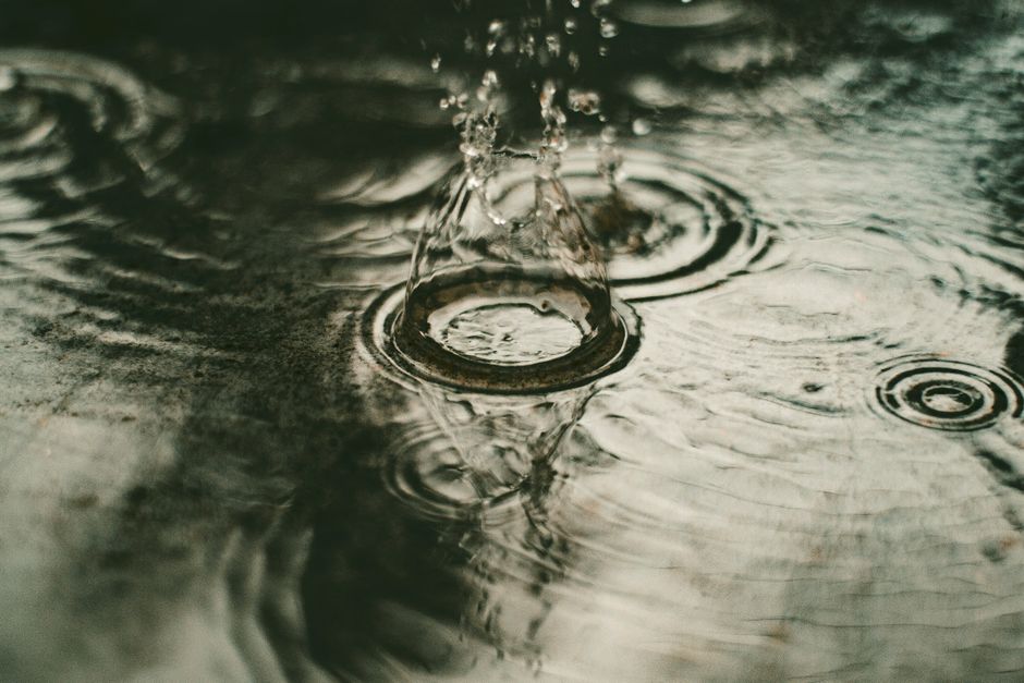 Close-up of a water drop creating ripples and splash. Perfect for nature and tranquility themes.